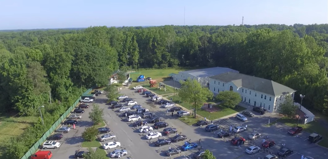 Aerial view of Islamic Society of Greater Charlotte campus and parking area on The Plaza