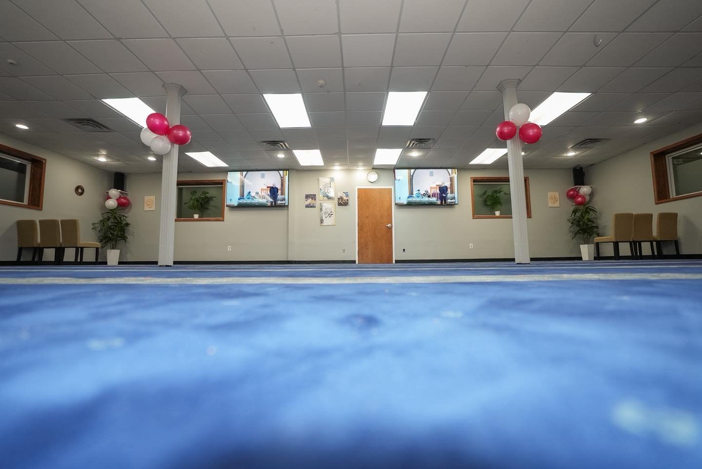 Masjid Al-Fajr prayer hall with blue carpet and prayer rows