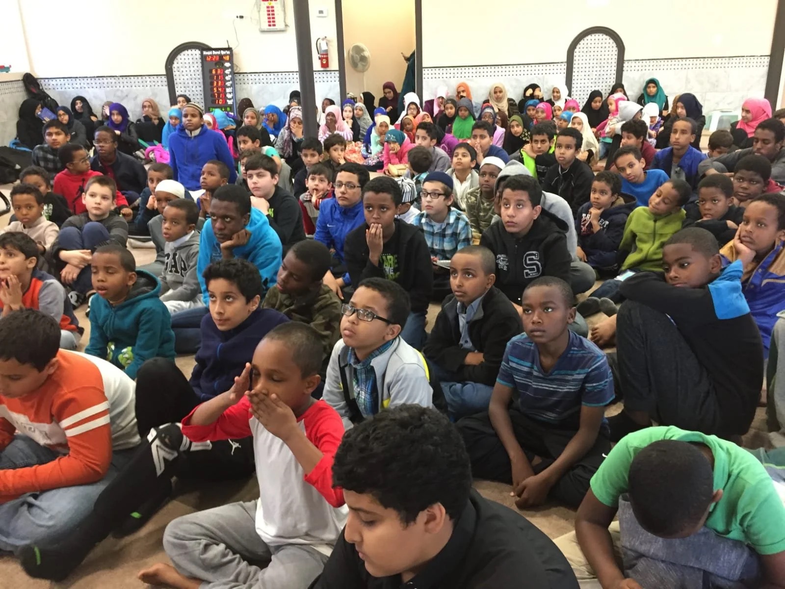 Youth and children seated for a Masjid Darul Quran program