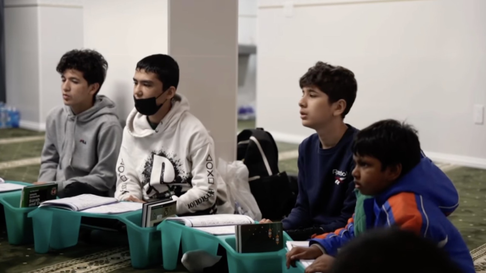 Students seated with books during a youth learning session at Islamic Center of Imam Abu Hanifa