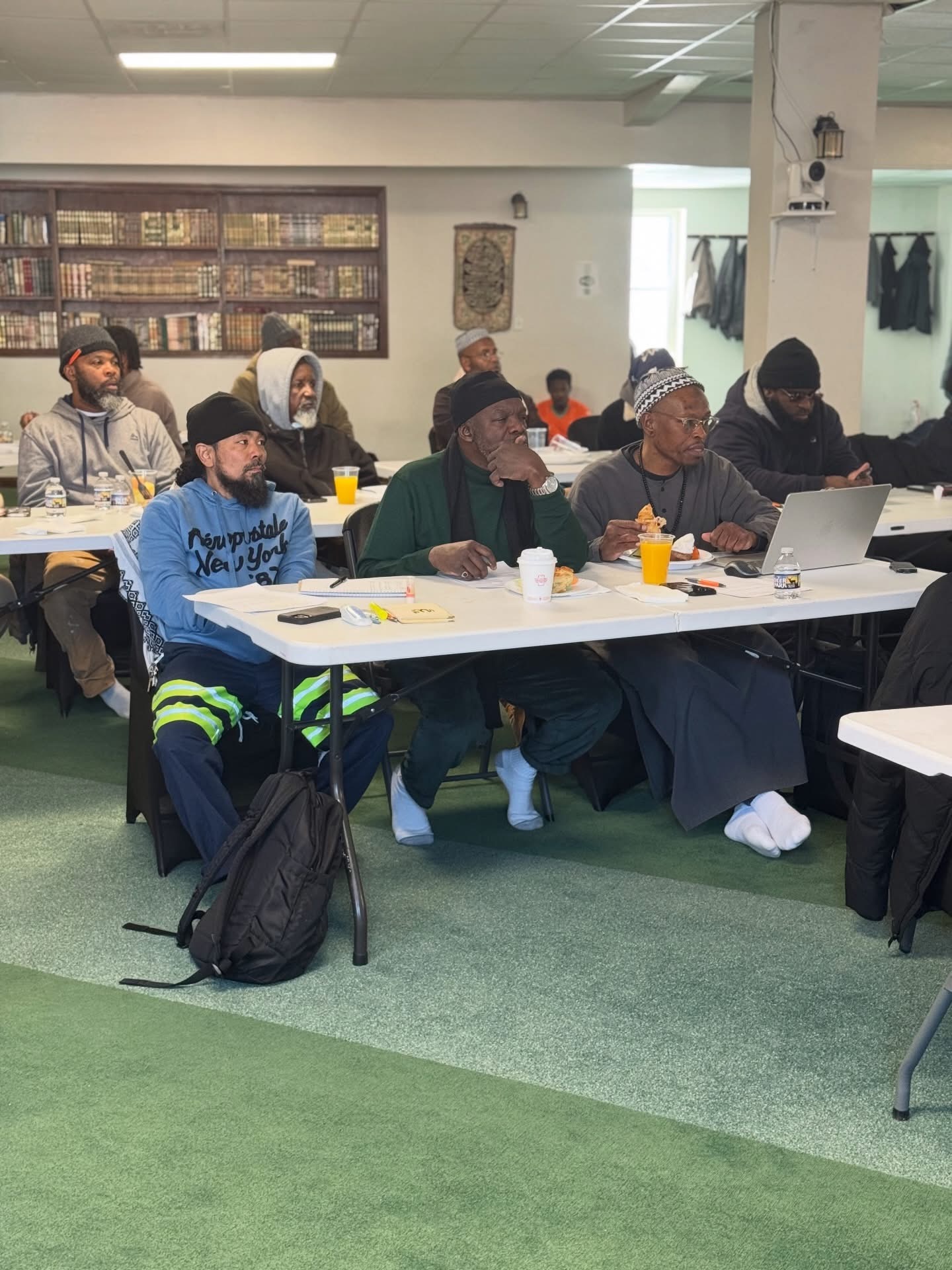 Masjid ul-Haqq community members seated for a class or meeting inside the masjid