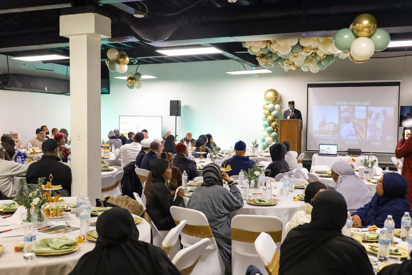 Masjid ul-Haqq community event space with attendees seated for a program in Baltimore