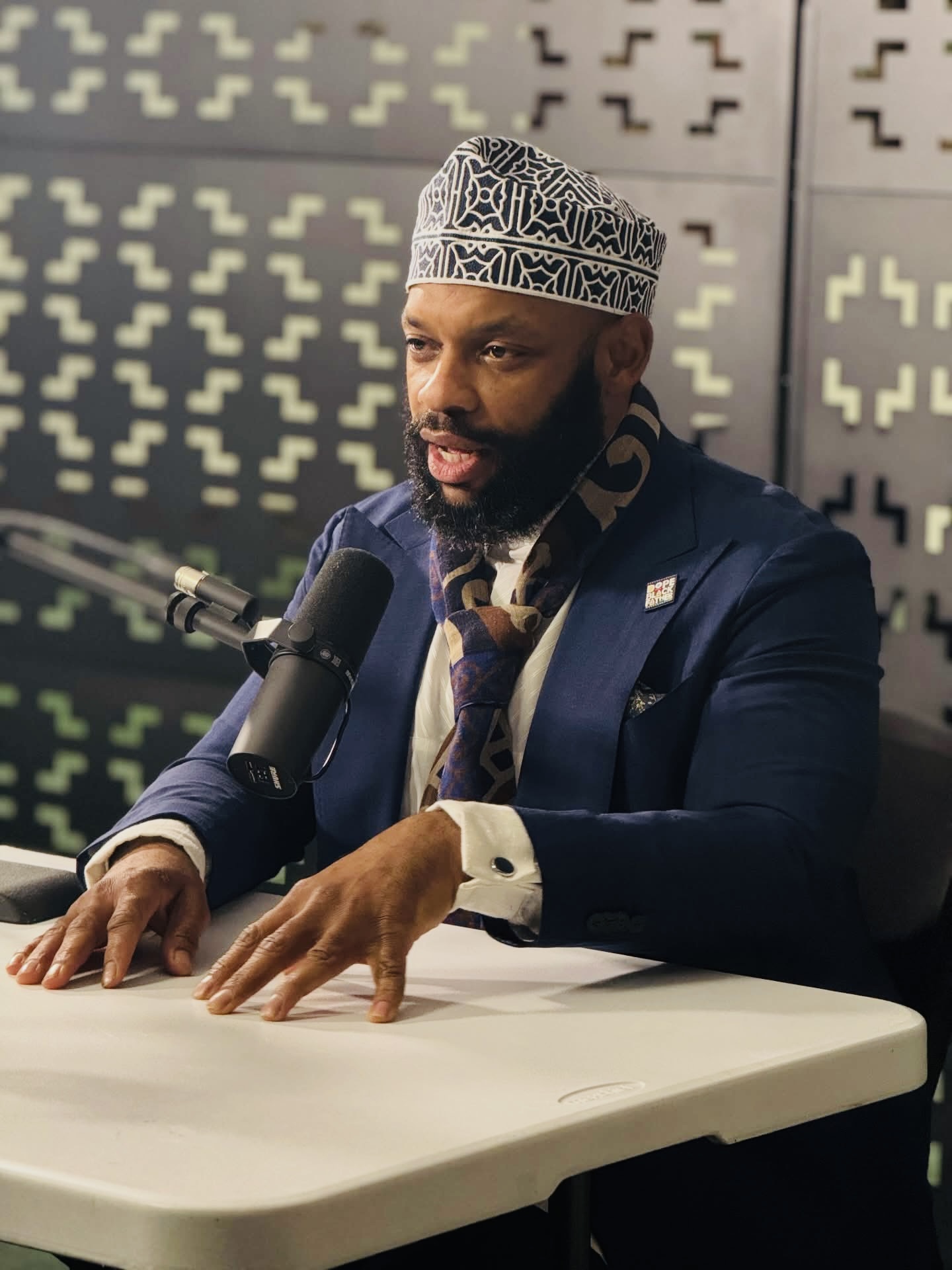 Masjid ul-Haqq imam speaking into a microphone during a recorded session