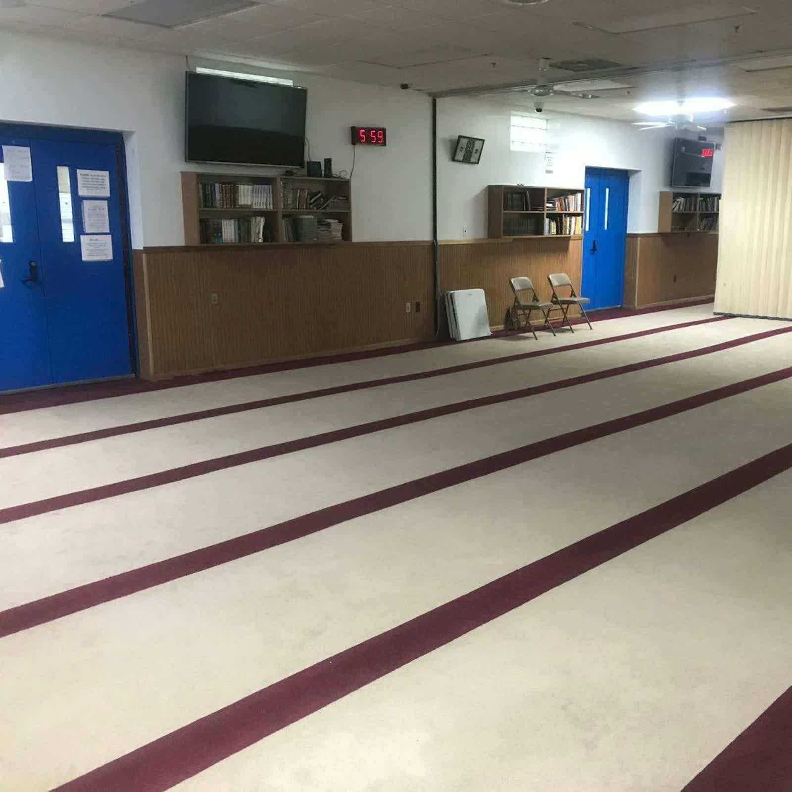 Masjid Umar bin Khattab interior prayer space and library shelves