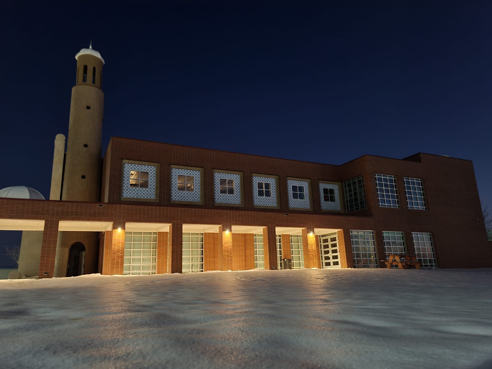 Front exterior of Mesquite Islamic Center lit in the evening