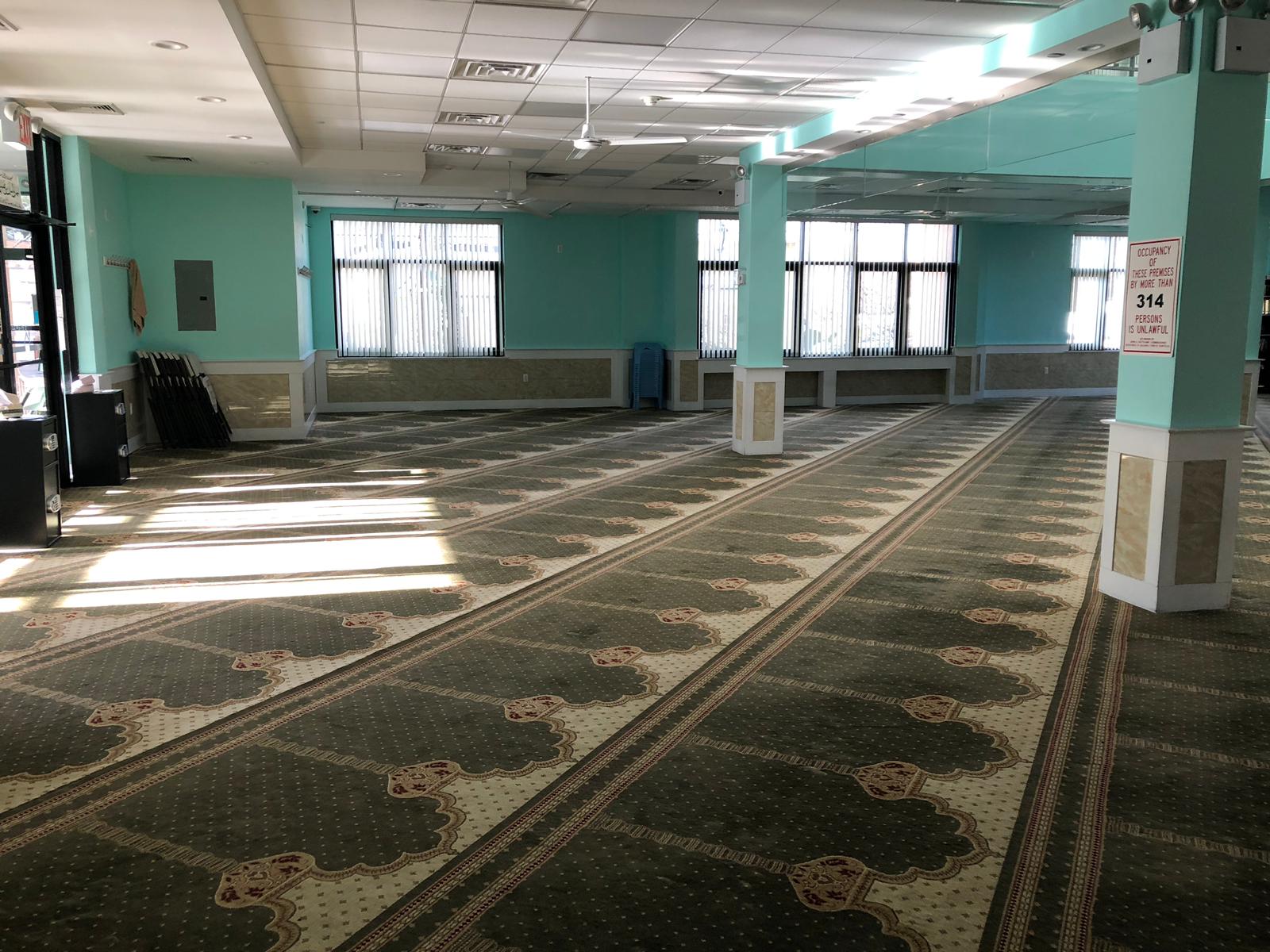 Muhammadi Masjid prayer space and capacity notice in Elmont, NY