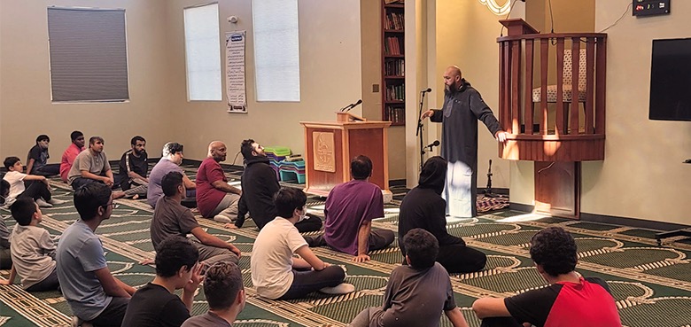 Muslim Community Center of Tucson prayer hall with worshipers seated for a lesson
