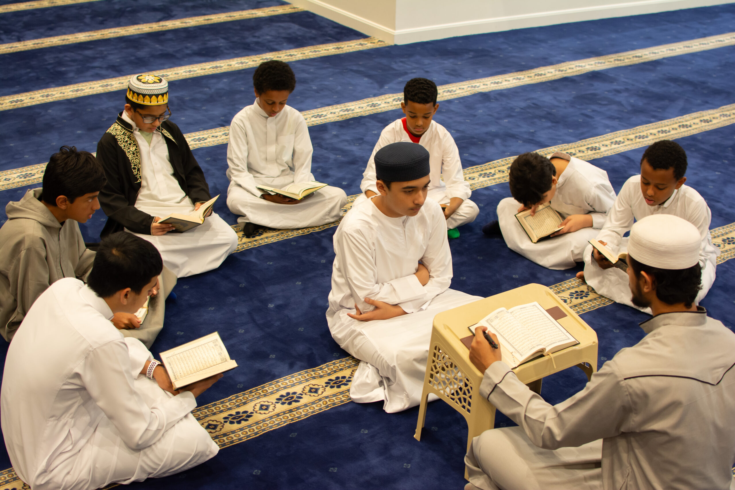 Sachse Muslim Society students reading Quran in the prayer hall